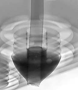 X-ray of THT through-hole solder joint showing internal solder fill level and fillet around a component lead.